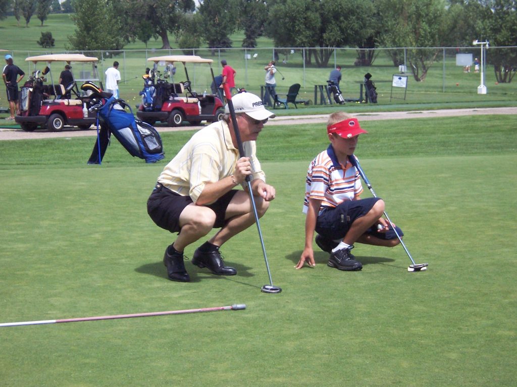 youth receiving golf lessons