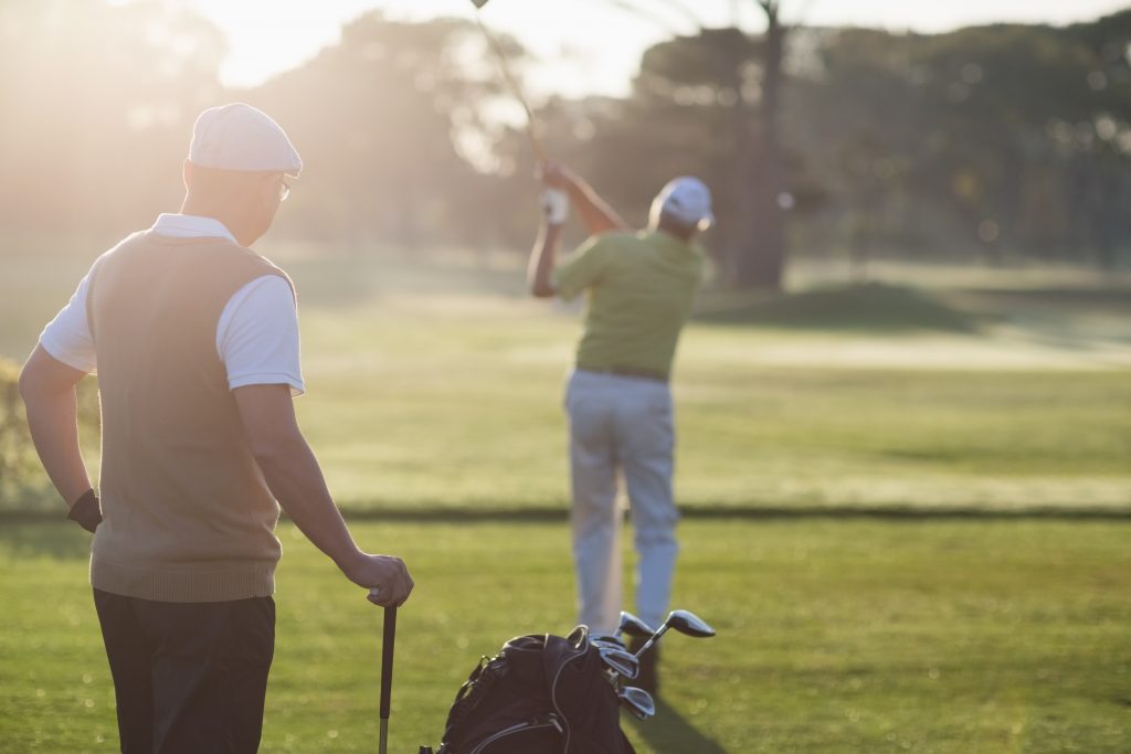 two golfers receiving golf lessons and instruction